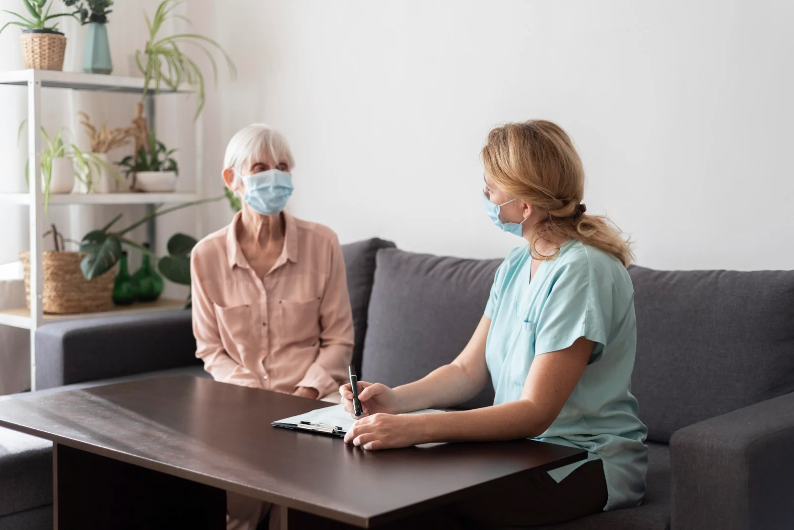 senior woman nursing home with nurse check up scaled 1